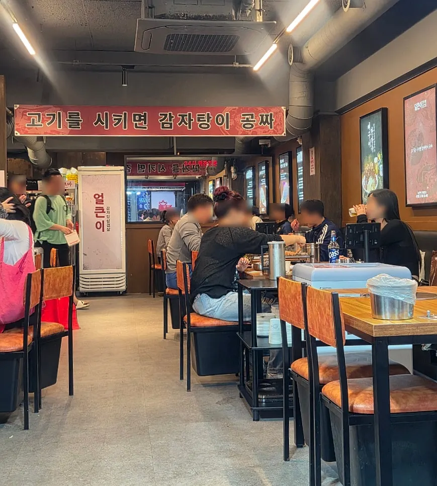 Interior of Eolkeuni Gamjatang Samgyeopsal Bupyeong Station Branch packed with customers