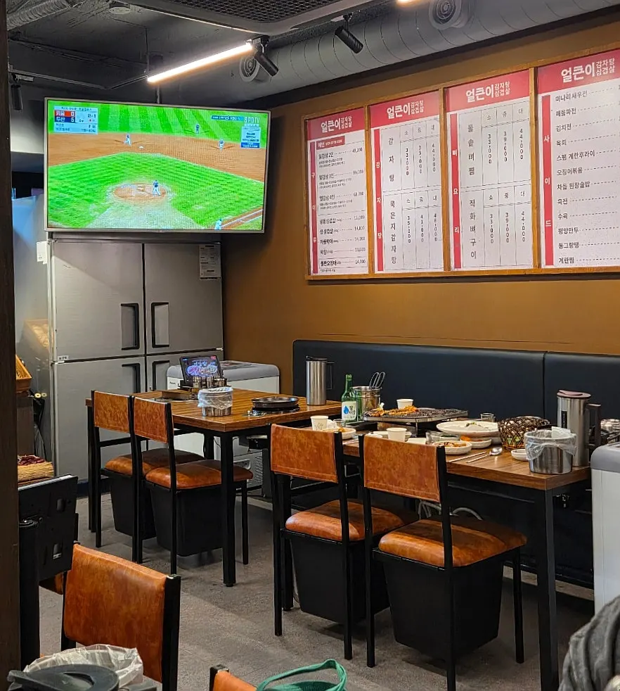Seating along the wall with a large TV installed