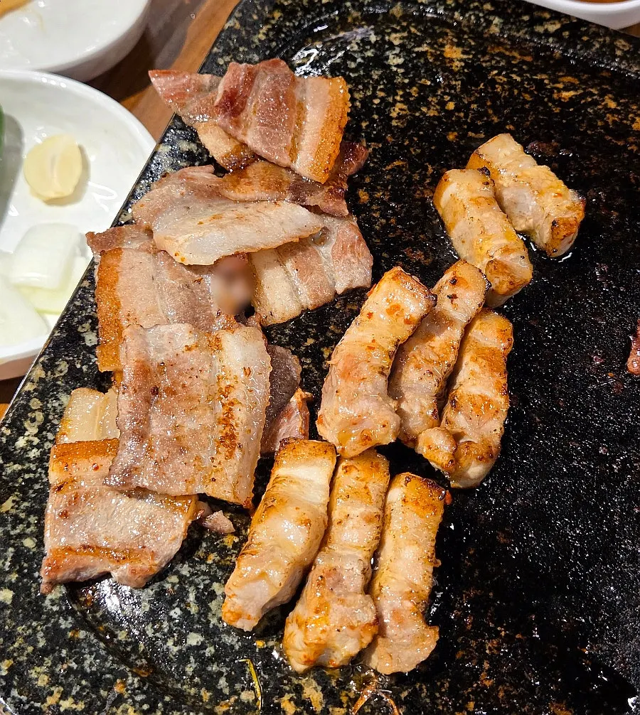 Owner torch-grilling pork belly