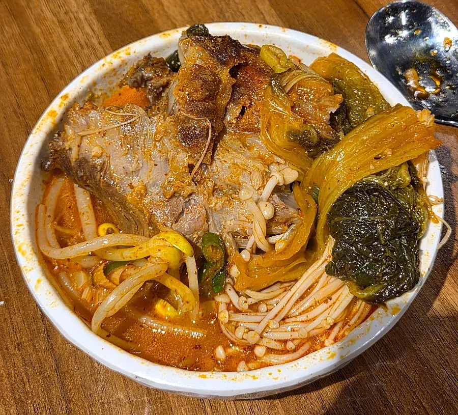 Spicy gamjatang broth with bean sprouts