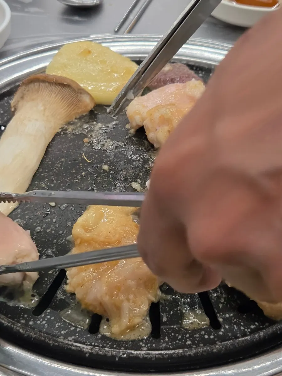 Salt-grilled yang gopchang cooking on the grill