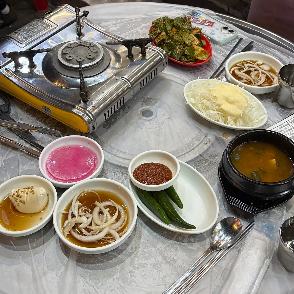 Side dish spread of doenjang jjigae and sundubu
