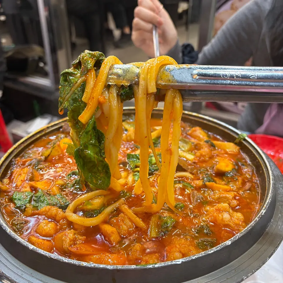 Pot of jeongol with spicy-sweet sauce left at the bottom