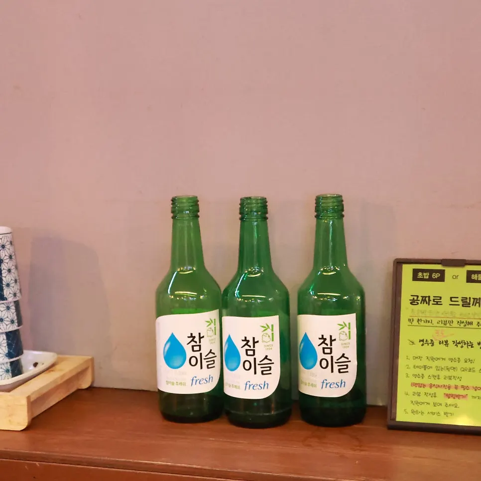 A piece of sashimi and a shot of soju