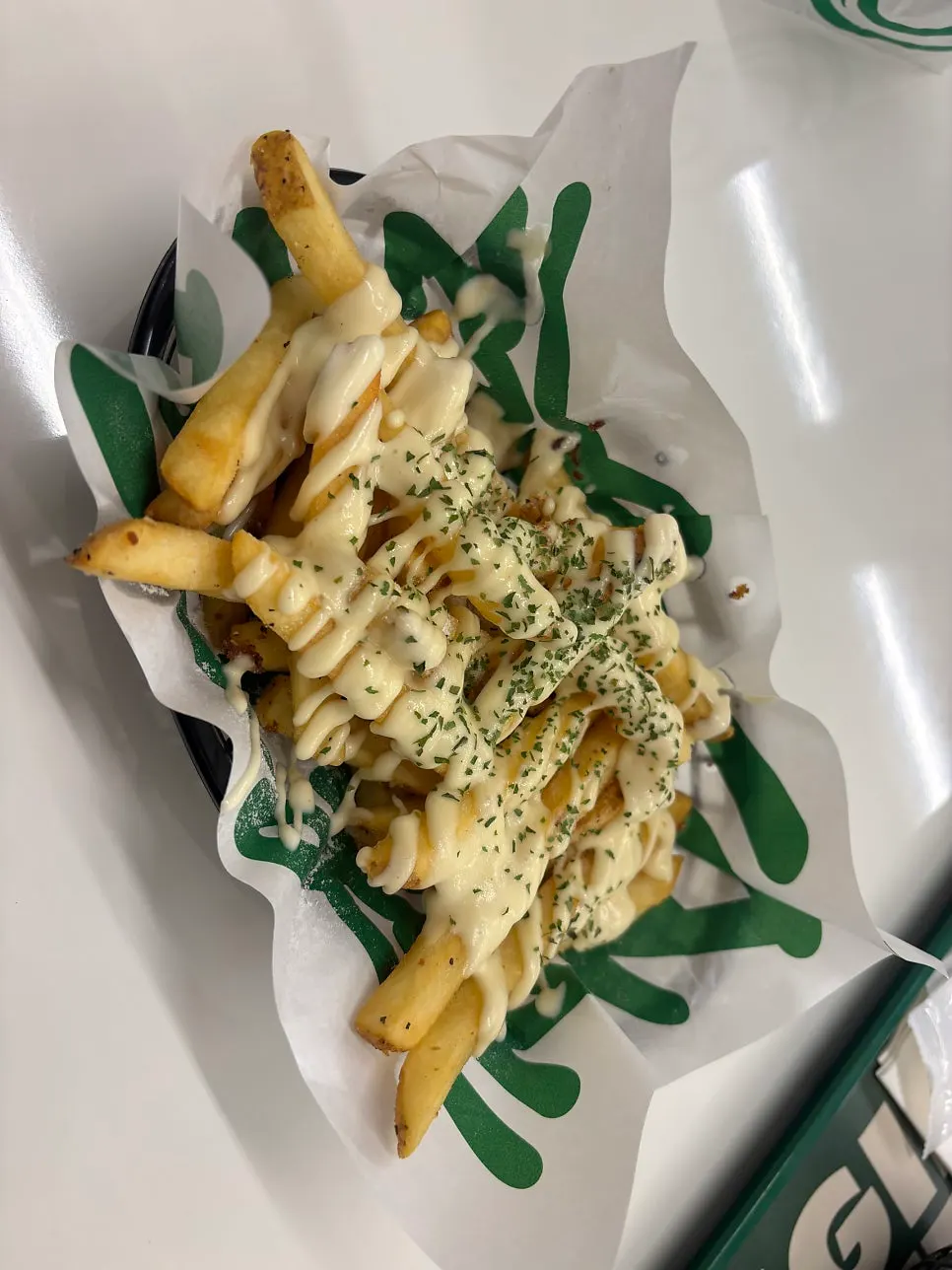 Fries drizzled with garlic butter sauce