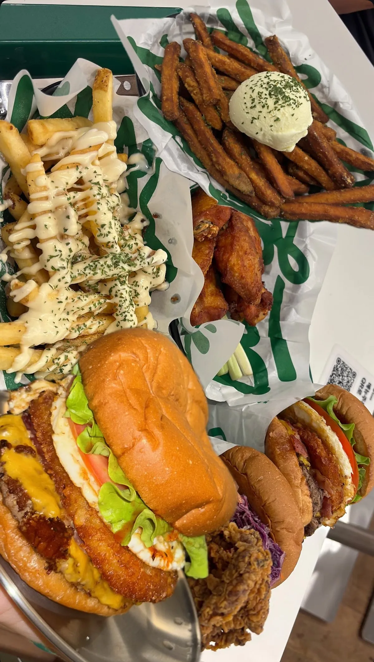 Full spread of Burgiz Daeheung burgers and sides