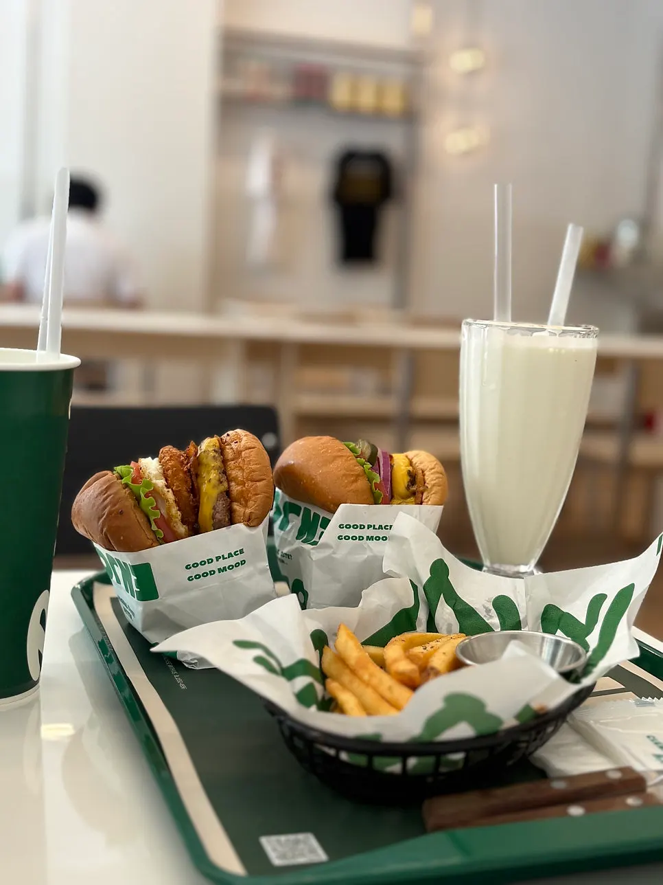 Full spread of burgers, fries, and milkshake