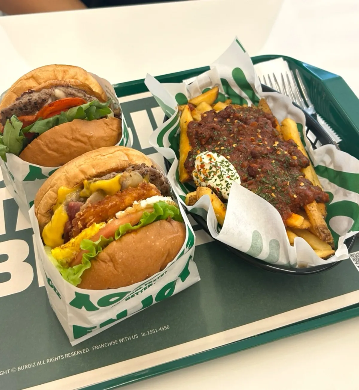 Chicago burger, Hangover burger, and chili fries laid out together