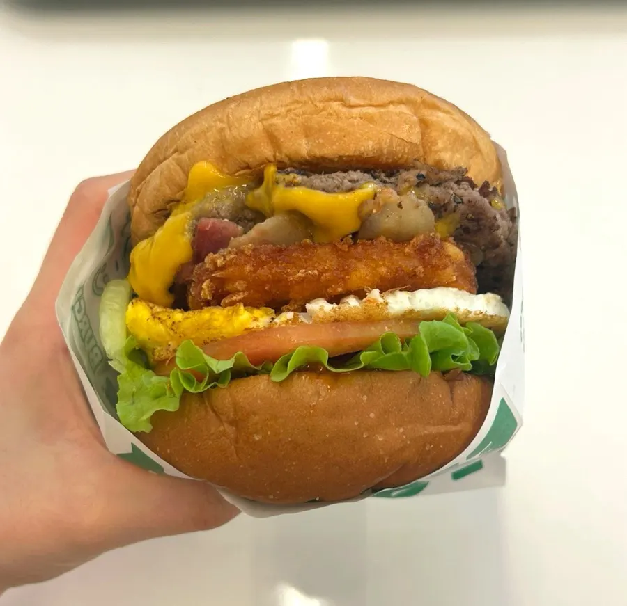 Hangover burger with hash brown and soft-fried egg inside