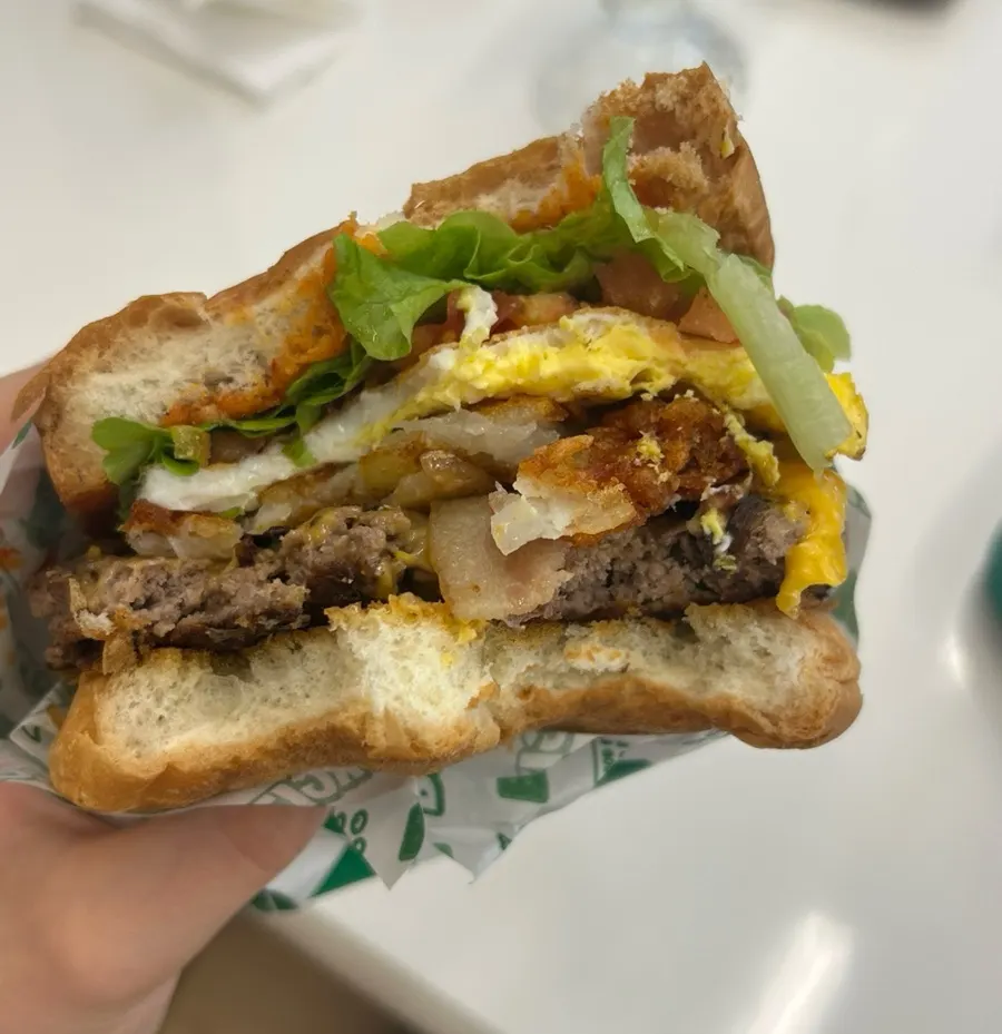 Cross-section of a thick handmade burger packed with fillings