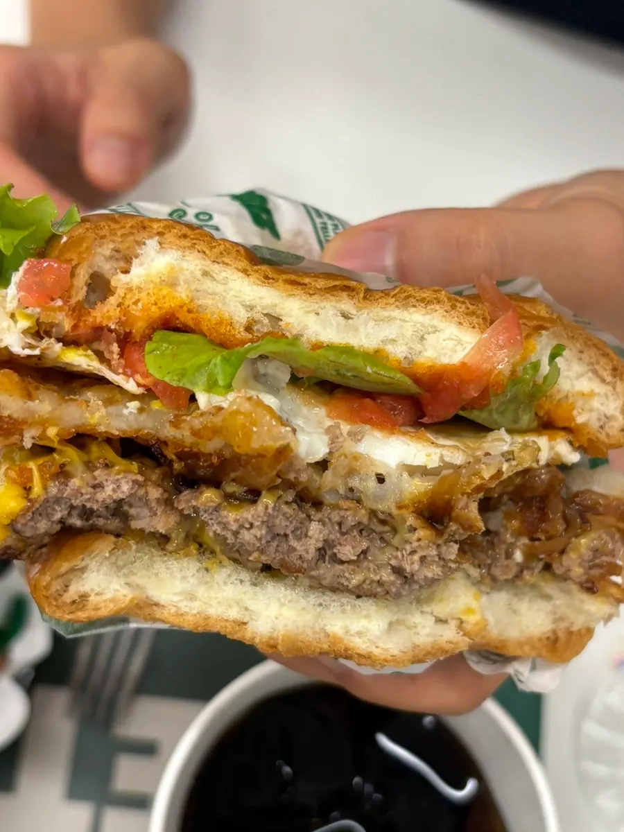 Cross-section of the Hangover burger with fried egg and hash brown