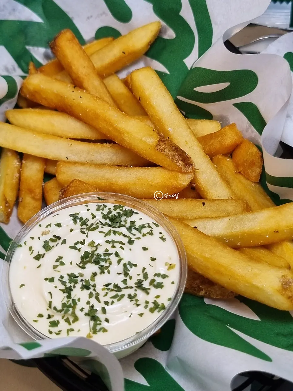 Fries dipped in garlic sauce