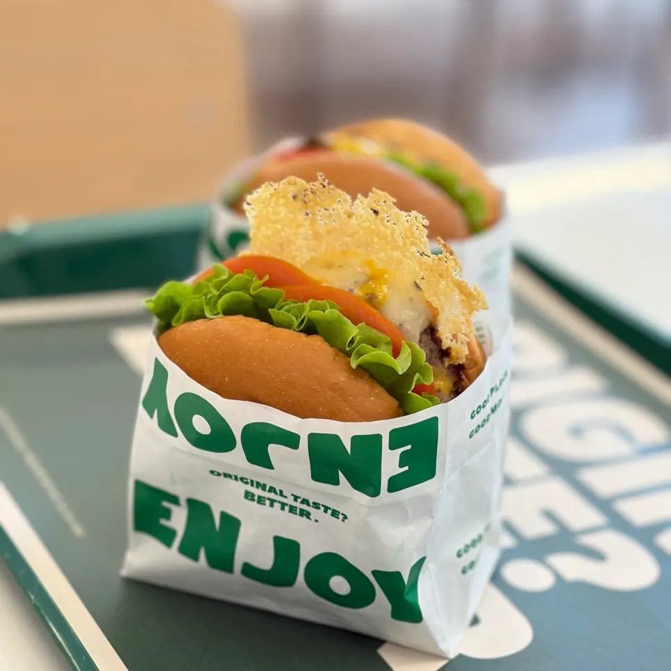 Holding the Cheese burger in hand