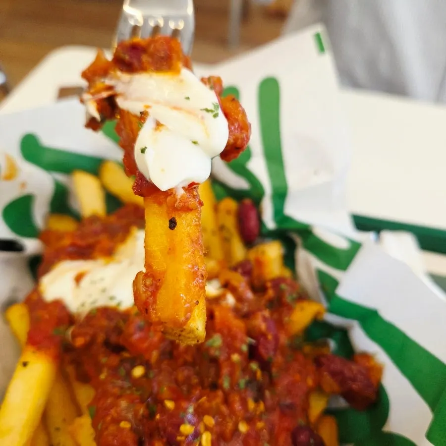 Chili fries topped with chili sauce and ranch sauce