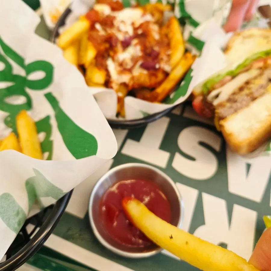Table with burger and fries served together
