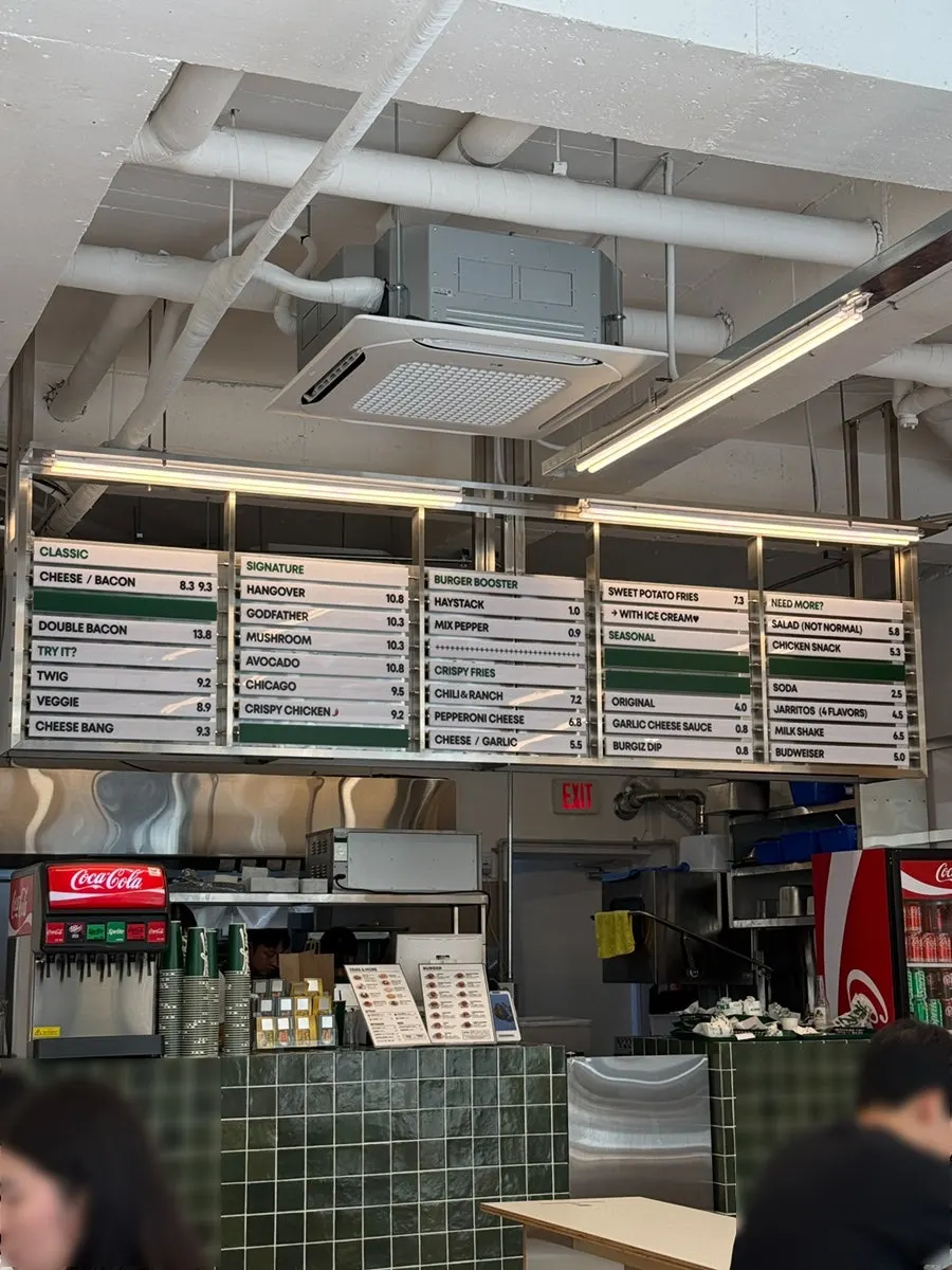 Full menu board hanging near the counter