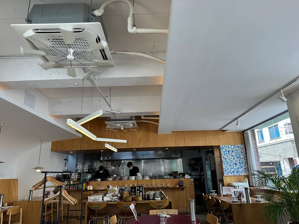 Dining hall seating lit by wide windows