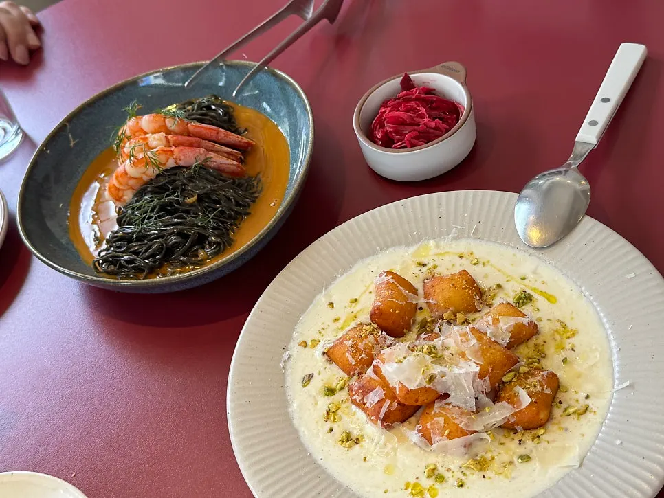 Squid-ink fresh pasta in orange bisque sauce