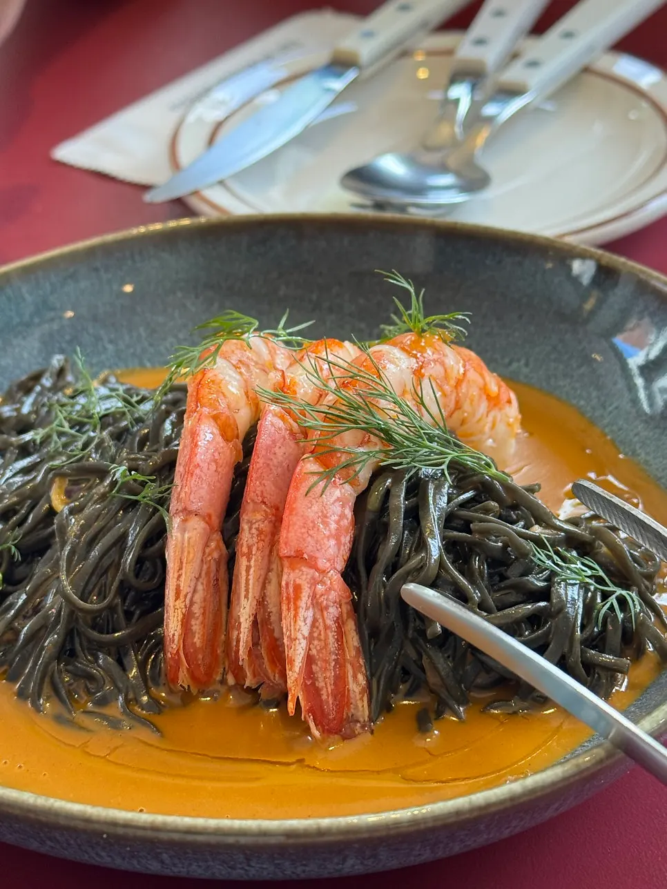 Squid-ink fresh pasta twirled on a fork