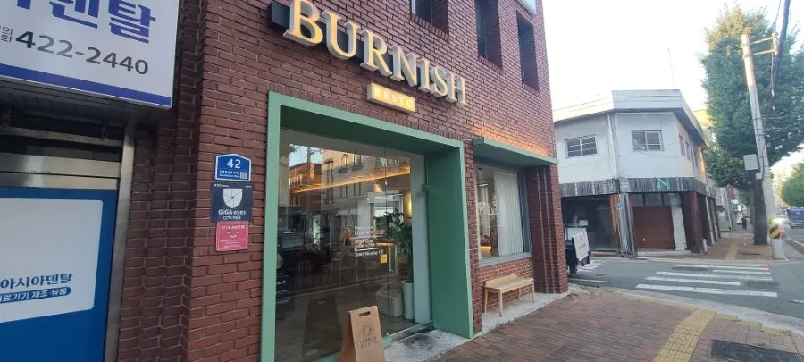 Entrance of Burnish Resto with gold-toned sign