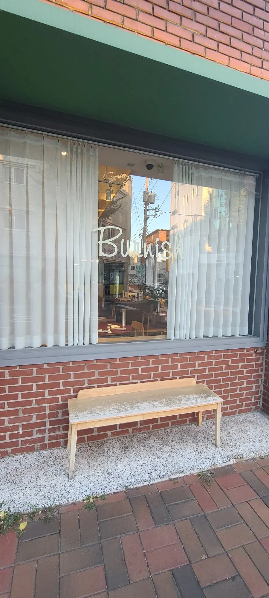 Full exterior view of Burnish Resto seen through the glass windows