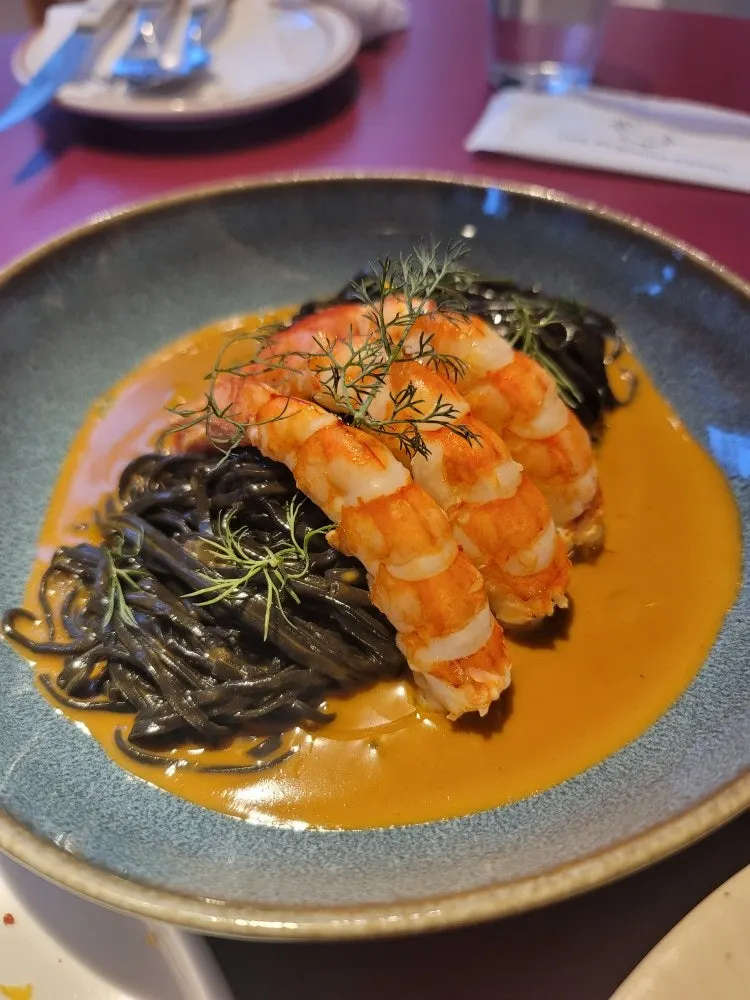Bisque fresh pasta topped with plump shrimp