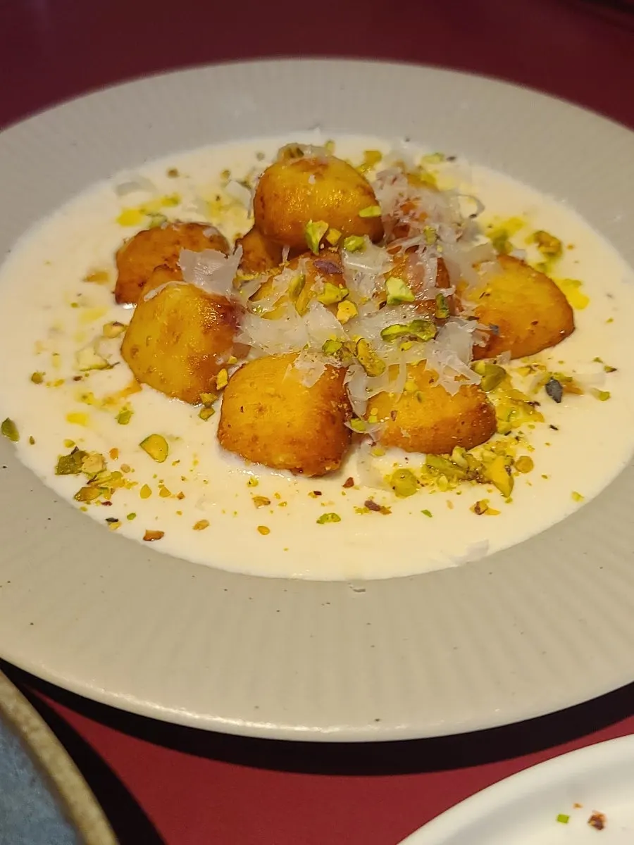 Gnocchi bites served with cream cheese sauce and nuts