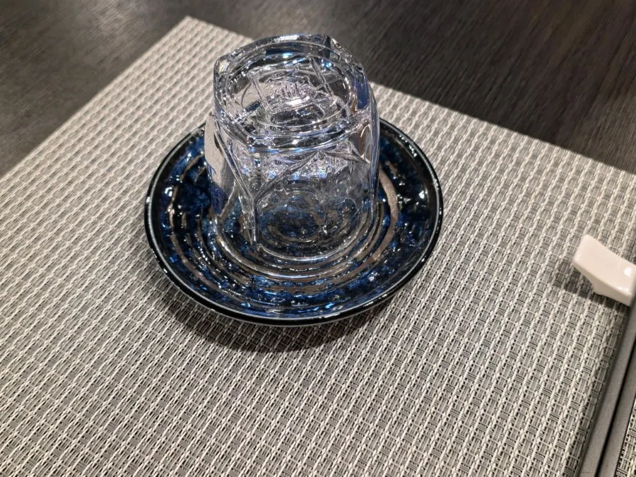 Table pre-set with Hwayo glasses, soju glasses, and small plates