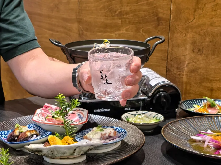 A shared plate of whale meat placed in the center of the table