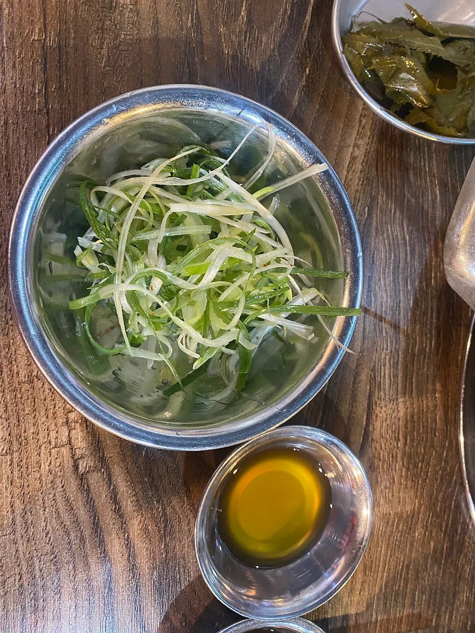 Side dishes of scallions and kimchi