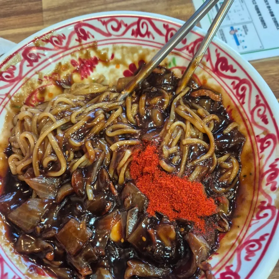 Japchae bap topped with red pepper flakes