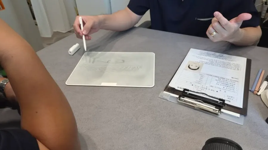 Consultation with the eyebrow design being drawn out