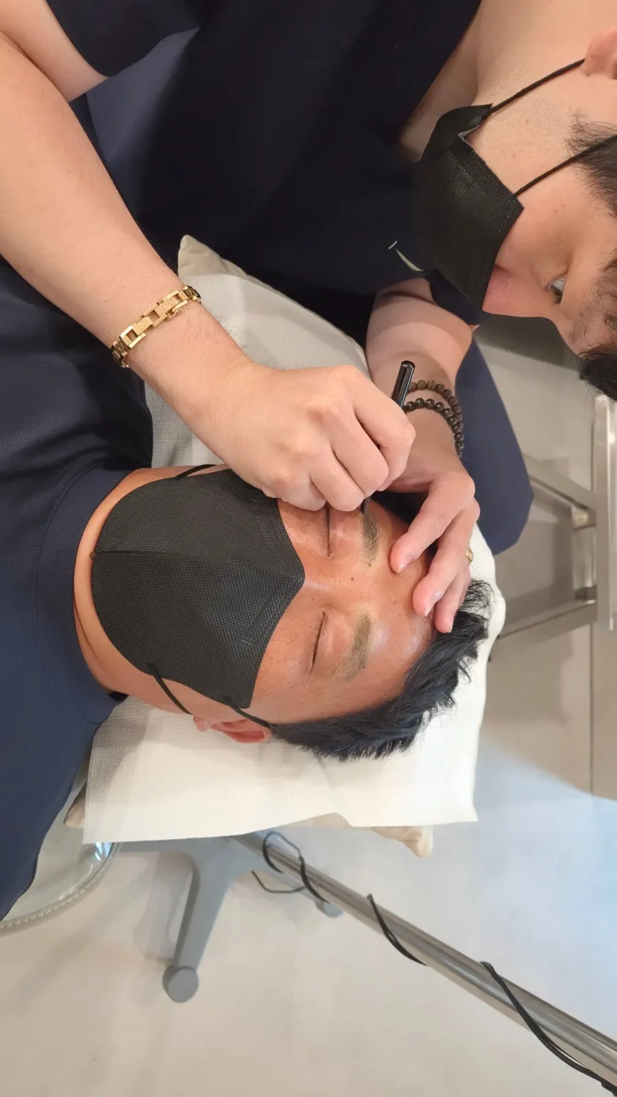 Eyebrows covered with wrap after numbing cream was applied
