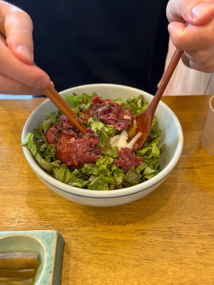 Raw beef bibimbap topped with round clusters of raw beef