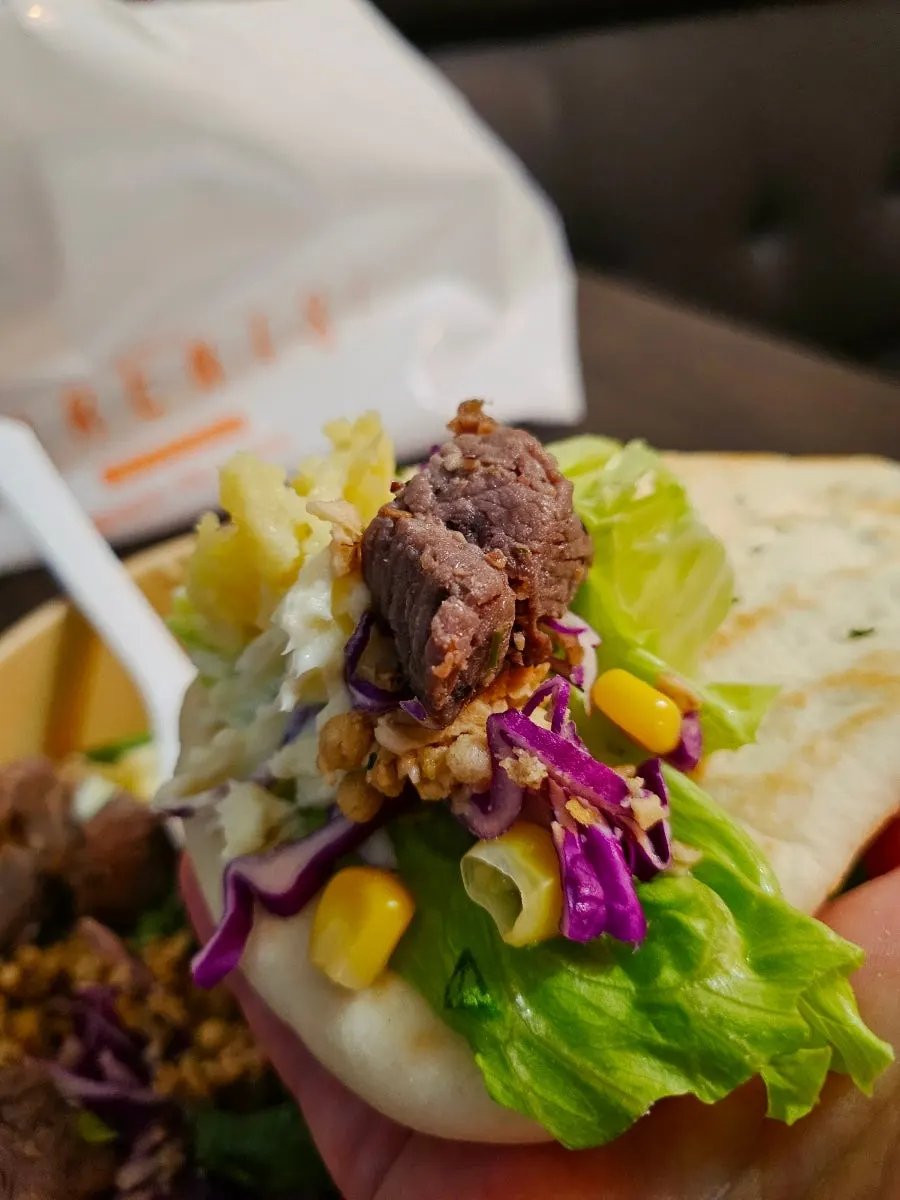 Three ordered salad takeout containers