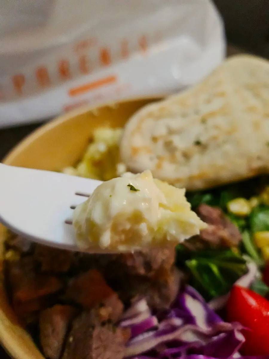 Sandwich made with bread, salad and skirt steak