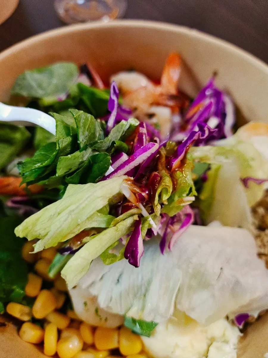 Bowl of poke mixed with pork neck and vegetables