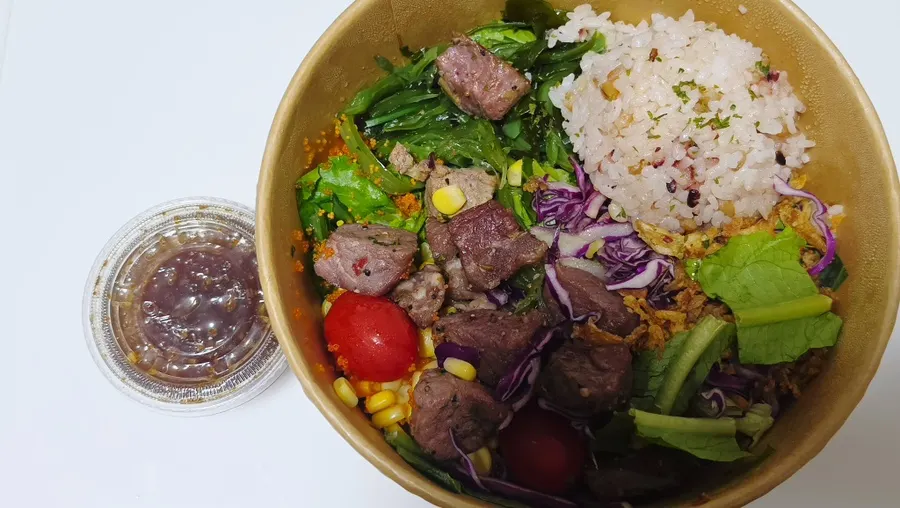 A bowl of seasoned pork poke on the table
