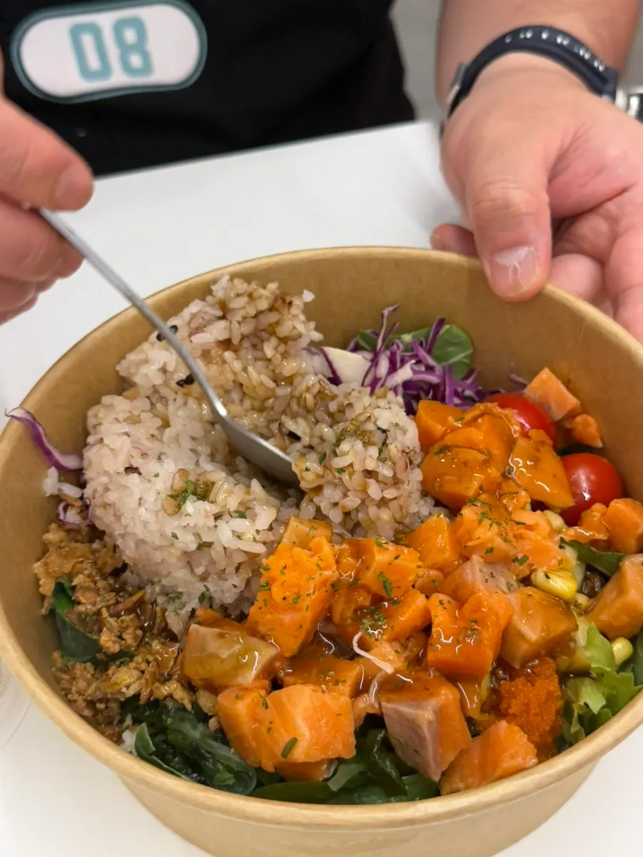 Raw salmon poke salad with wasabi soy sauce dressing