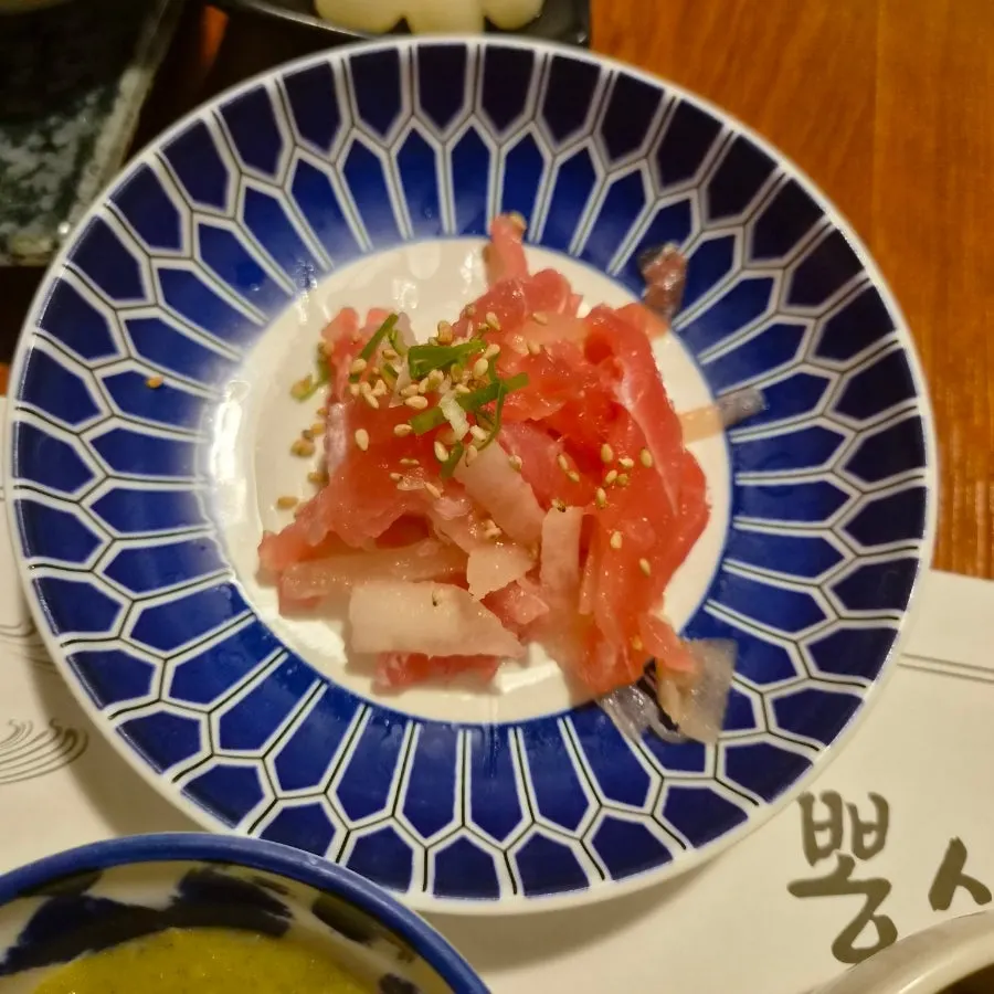 Fresh fish, shrimp, and seasoned sushi with side dishes