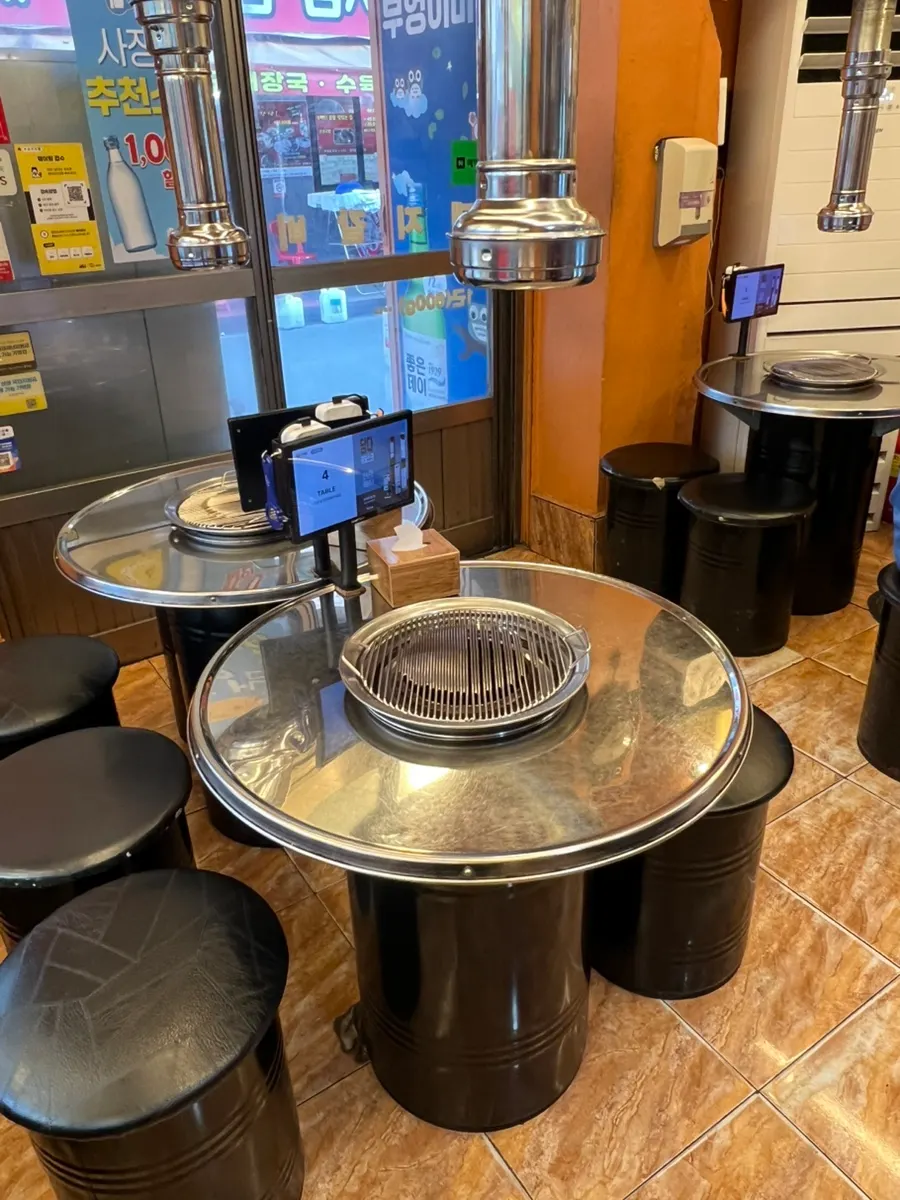 Pojangmacha-style interior with round metal tables