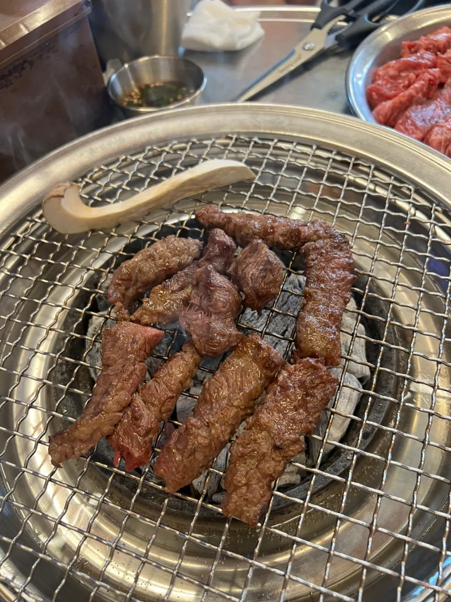 Beef rib meat cooking over charcoal