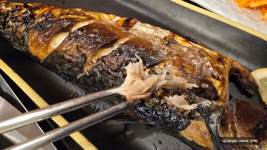 Moist mackerel flesh picked apart after grilling