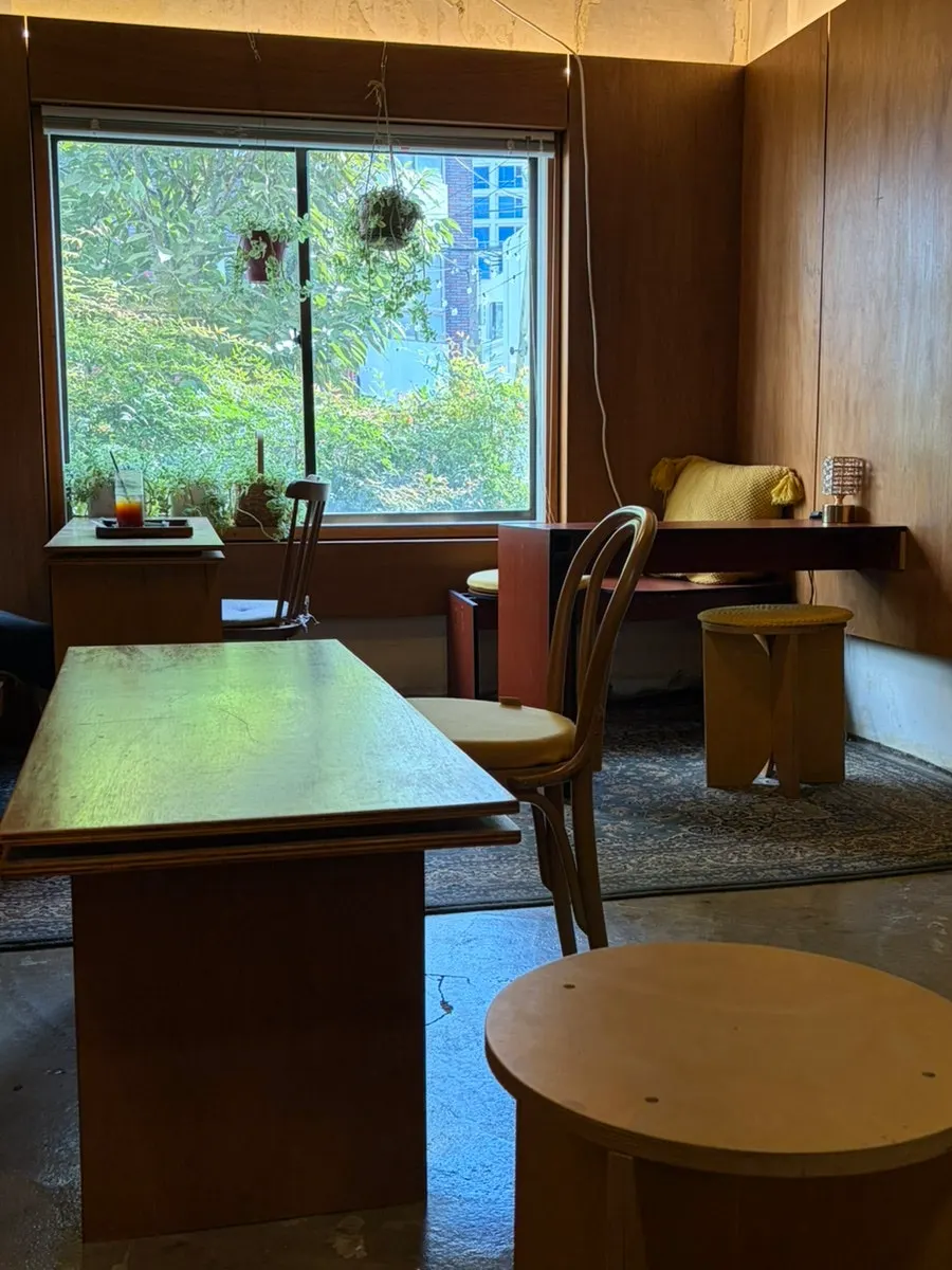 Spacious café seating with wood-toned wooden furniture