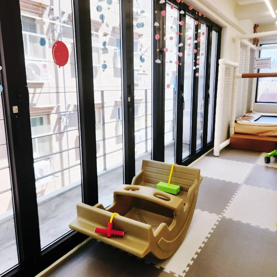 Gross-motor play area with an indoor seesaw