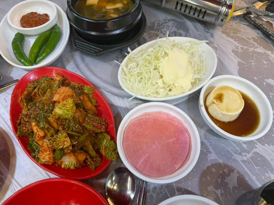 Side dishes and warm broth at Bupyeong Yang Gopchang