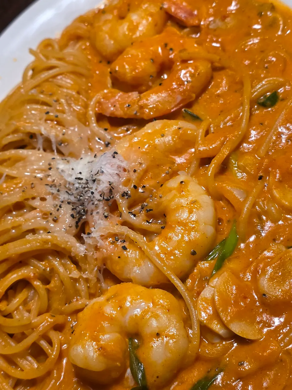 Shrimp rosé pasta eaten with a child