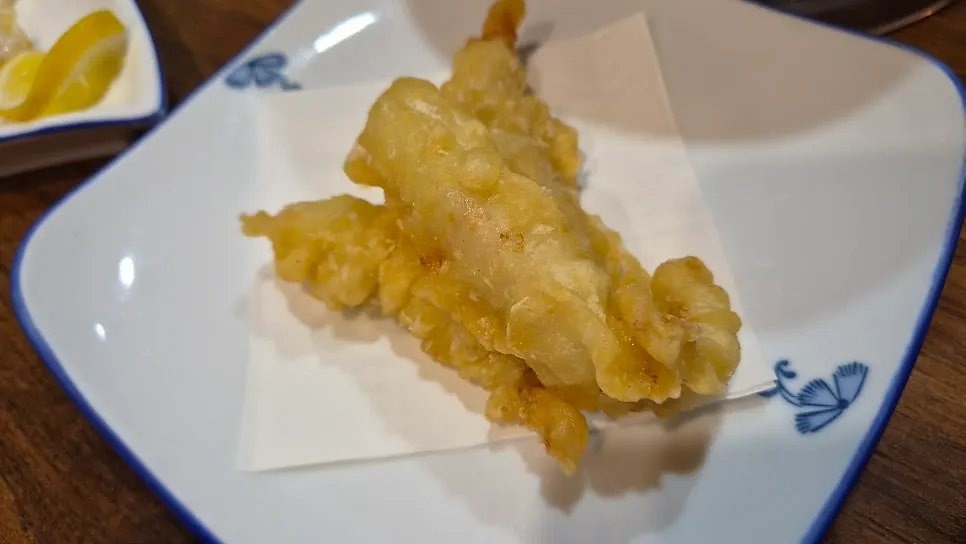 A piece of steamed pufferfish with water dropwort and bean sprouts