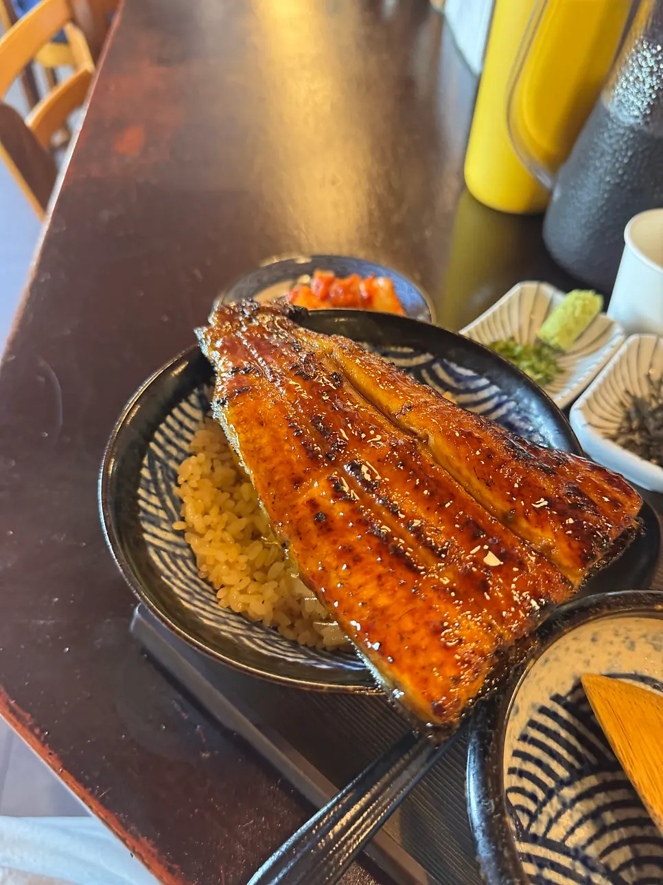 Charcoal-grilled eel being sauced