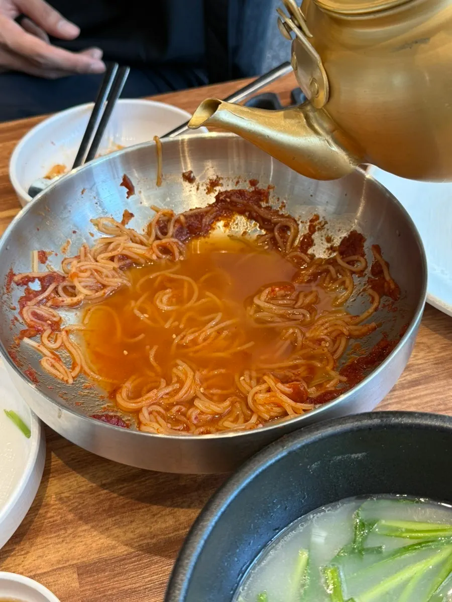 Warm broth served in a gold-colored kettle